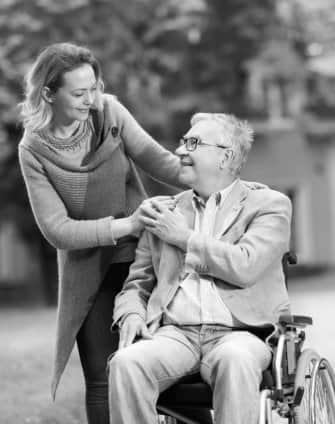 a caregiver and an elder man on the wheelchair